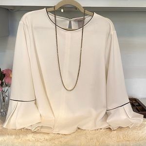 White with black trim and flare sleeves blouse.